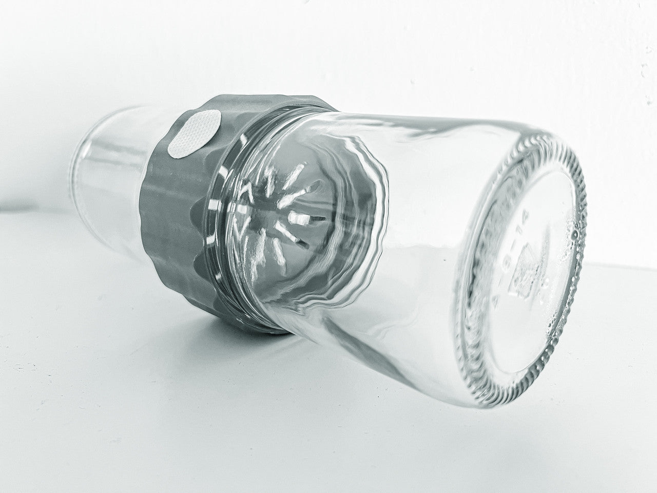 Side view image of the glass BioCoupler set laying on a flat surface.