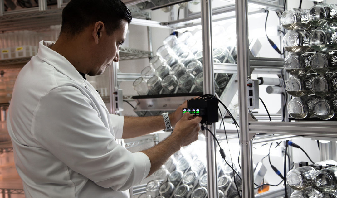 Scientist programming BioTilt bioreactor system for automated immersion and rotation in tissue culture