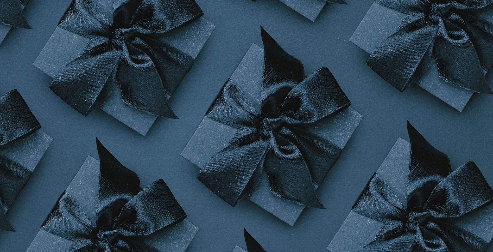 Pattern of dark blue present boxes on a matching background promoting Black Friday and Cyber Monday Sales